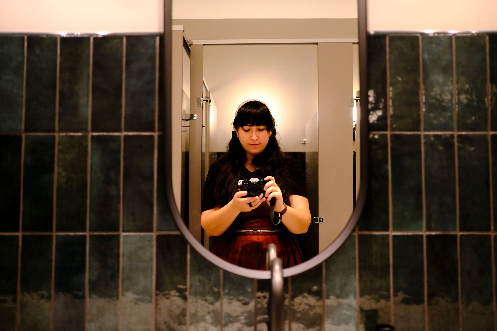 woman her mid thirties bathroom mirror dusk phone hand one dress discarded the floor