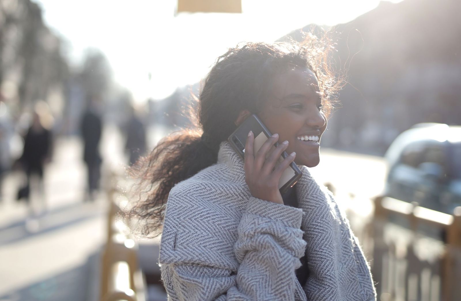 a woman walking outside in daylight, jacket on, phone in her pocket || woman walking outside jacket phone her pocket thirties