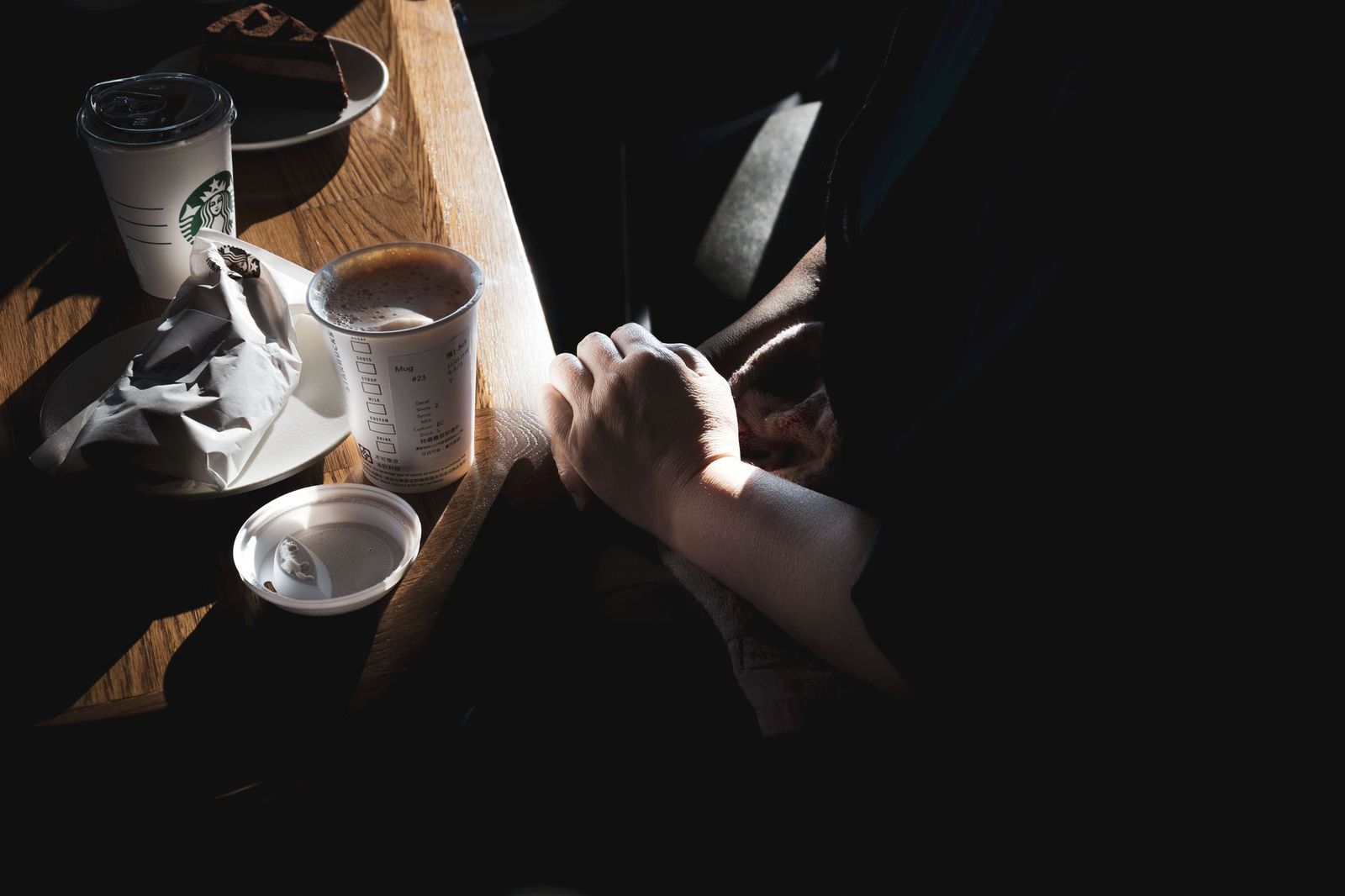 woman her late thirties sitting the floor bathroom knees pulled one phone hand door closed sec two coffee cups kitchen table one with lipstick the other with ring cream light sec couple their thirties sitting park bench talking hands not touching