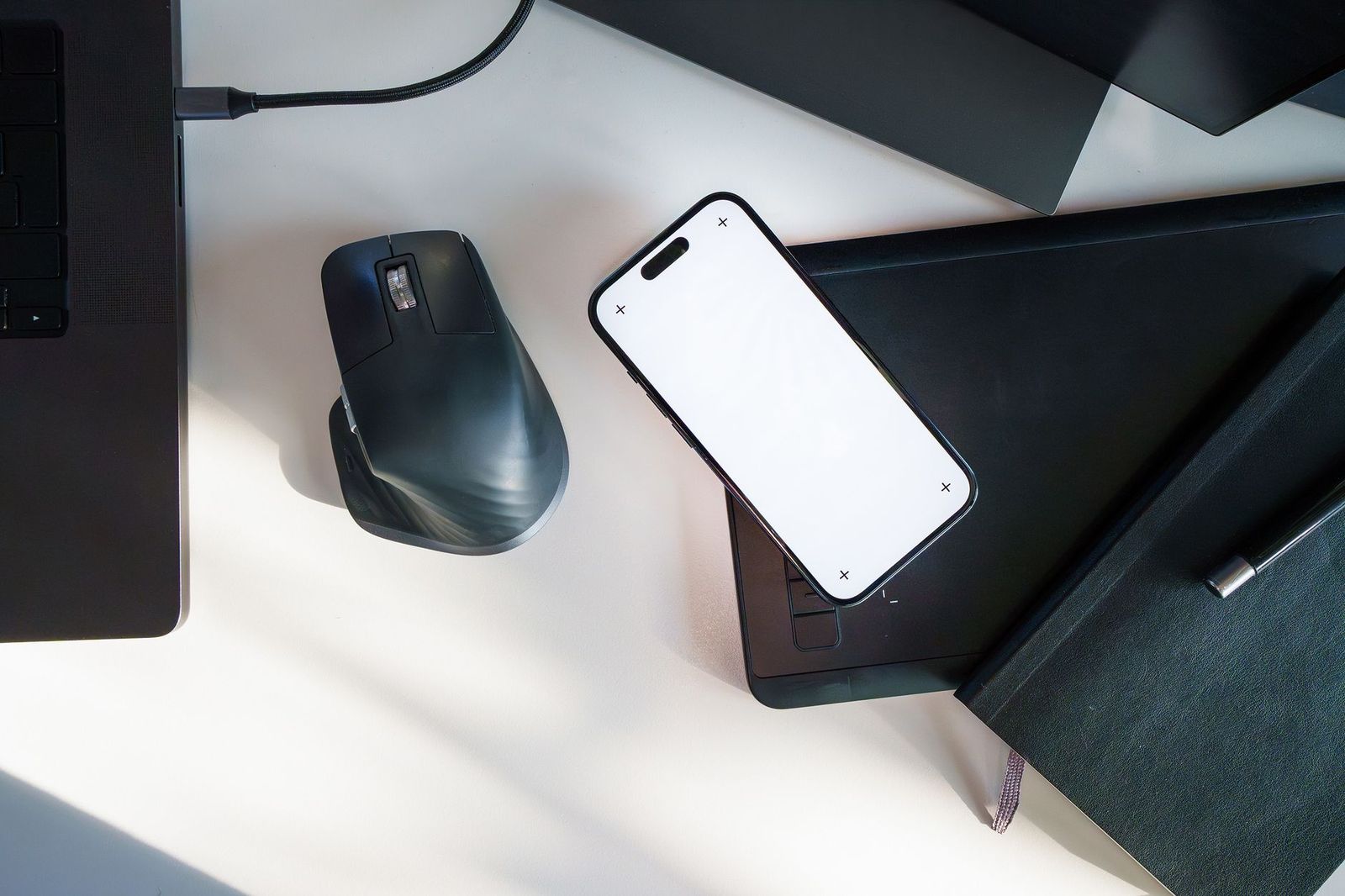 a phone face down on a desk between two nameplates, empty office after hours || phone face down desk between two nameplates empty office after hours
