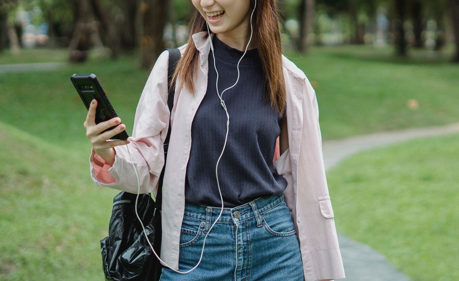 the same woman walking outside in daylight, phone in her pocket, looking unbothered. || the same woman walking outside phone her pocket looking unbothered thirties