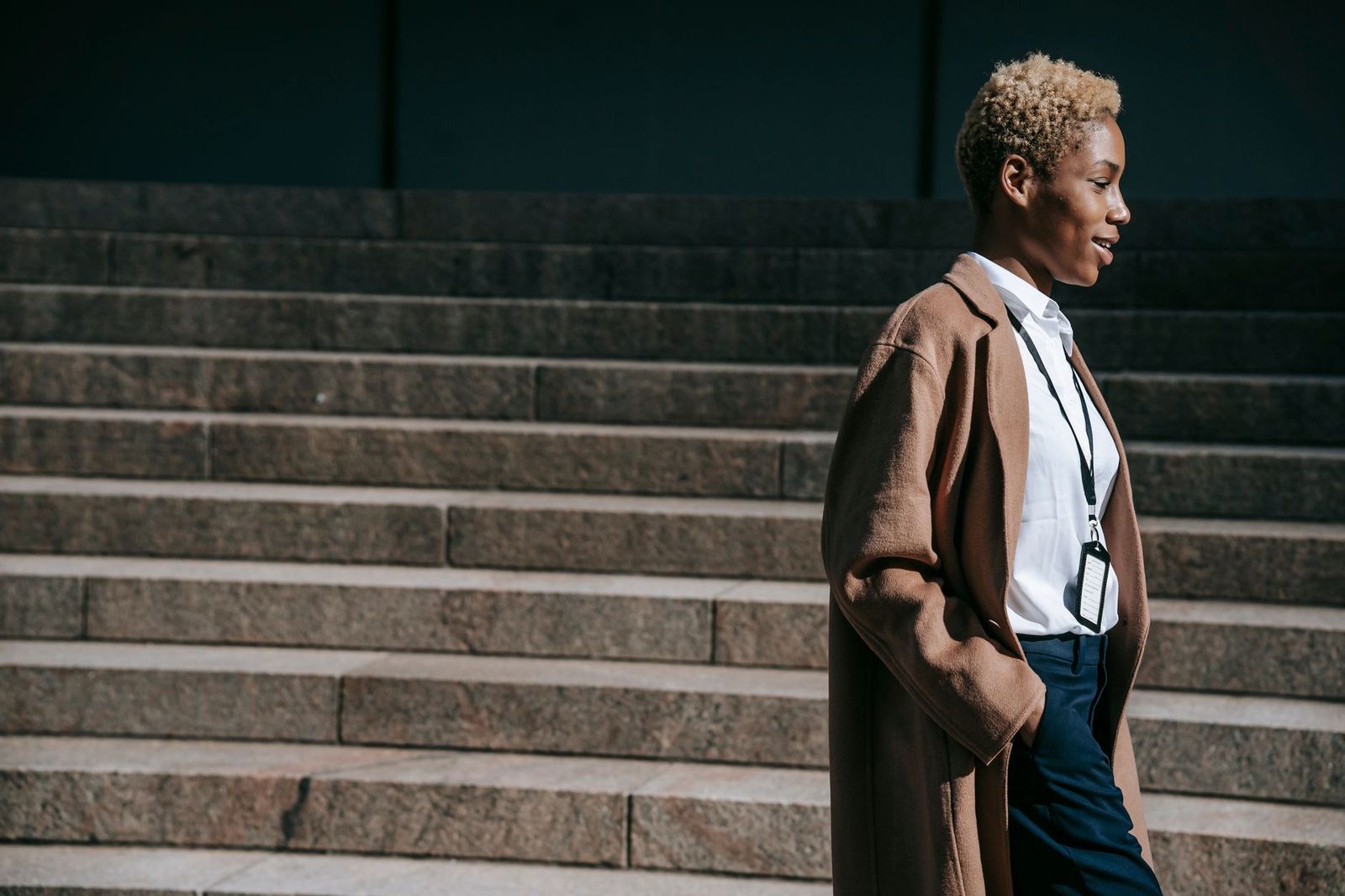 a woman in her forties walking outside in daylight, phone in her pocket || woman her forties walking outside phone her pocket thirties