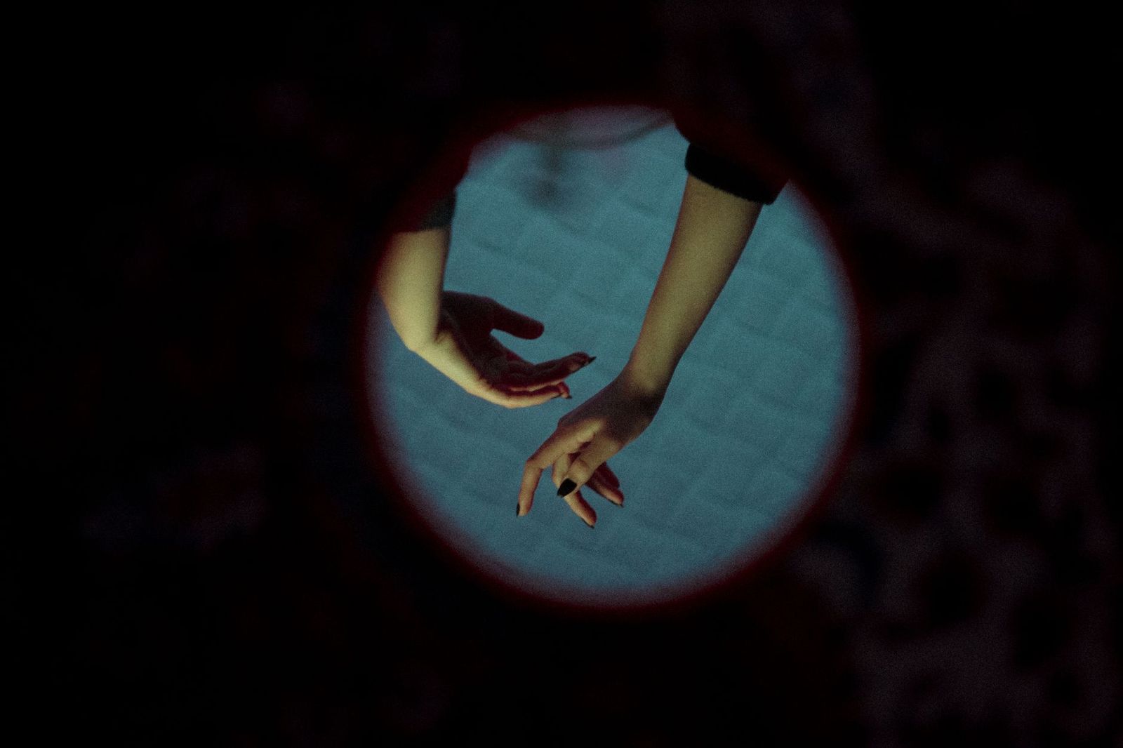 two hands reaching for each other on a bed, a bedside lamp in the frame, no explicit body parts. || two hands reaching for each other bed bedside lamp the frame explicit body parts