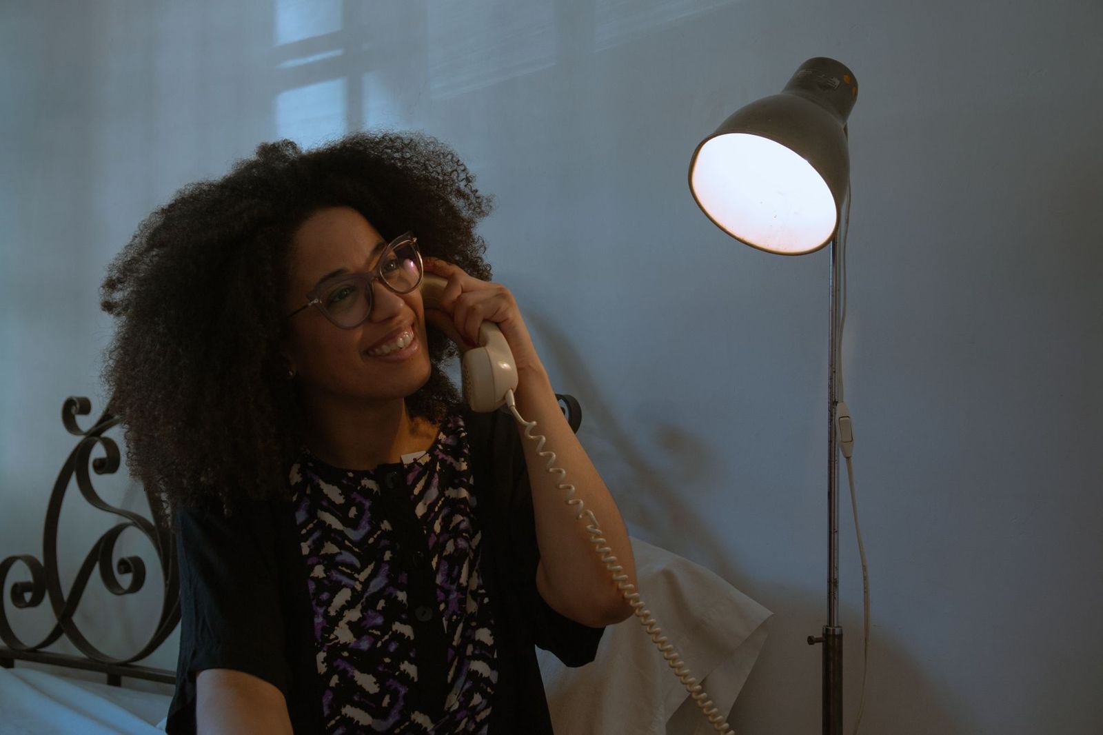 woman her mid thirties standing doorway looking man couch phone light his face lamp