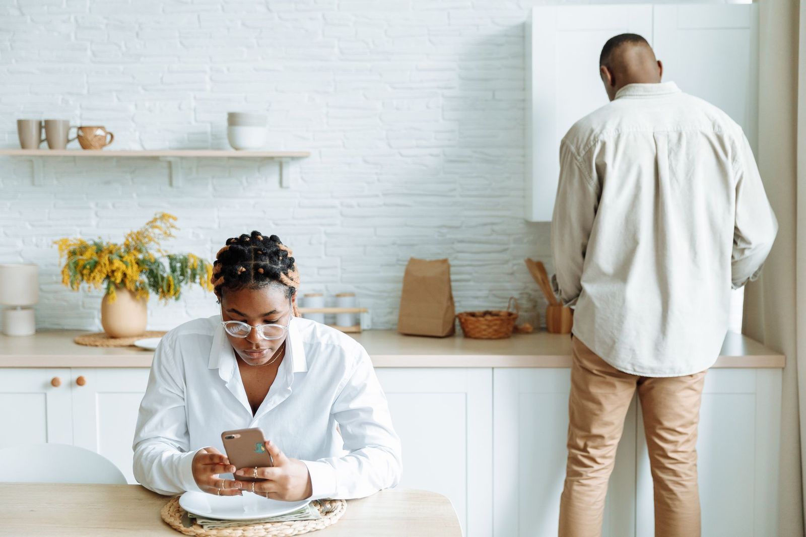 two phones face-down on a kitchen counter || two phones face down kitchen counter
