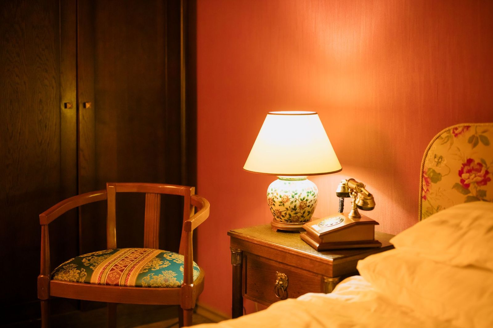 A phone face down on a nightstand in the dark