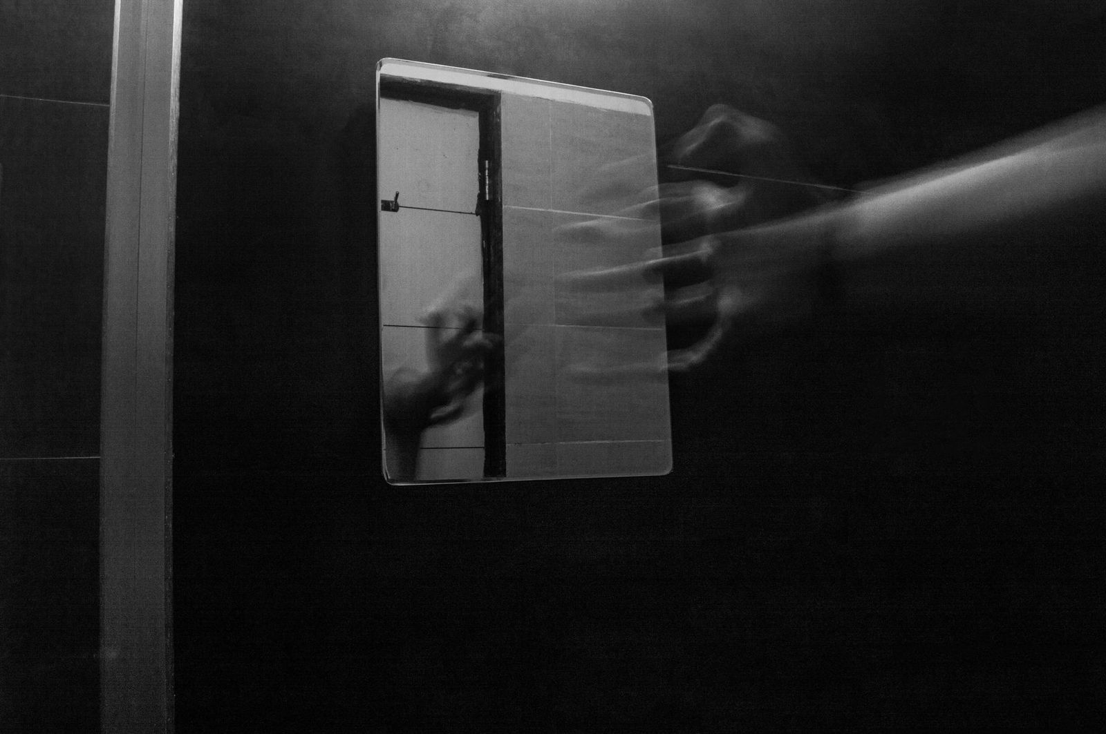 woman her thirties bathroom floor with hand mirror lighting from phone looking her vulva key object the mirror