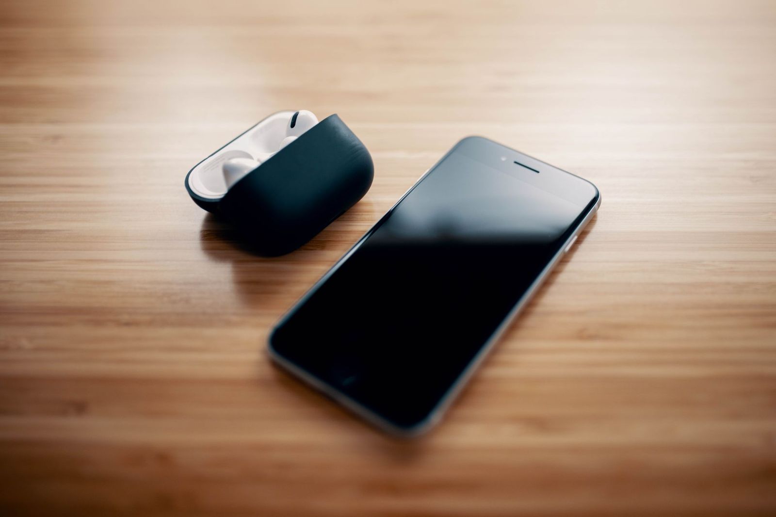 a smartphone charging in another room on a dresser at night, out of reach from bed || smartphone charging another room dresser out reach from bed
