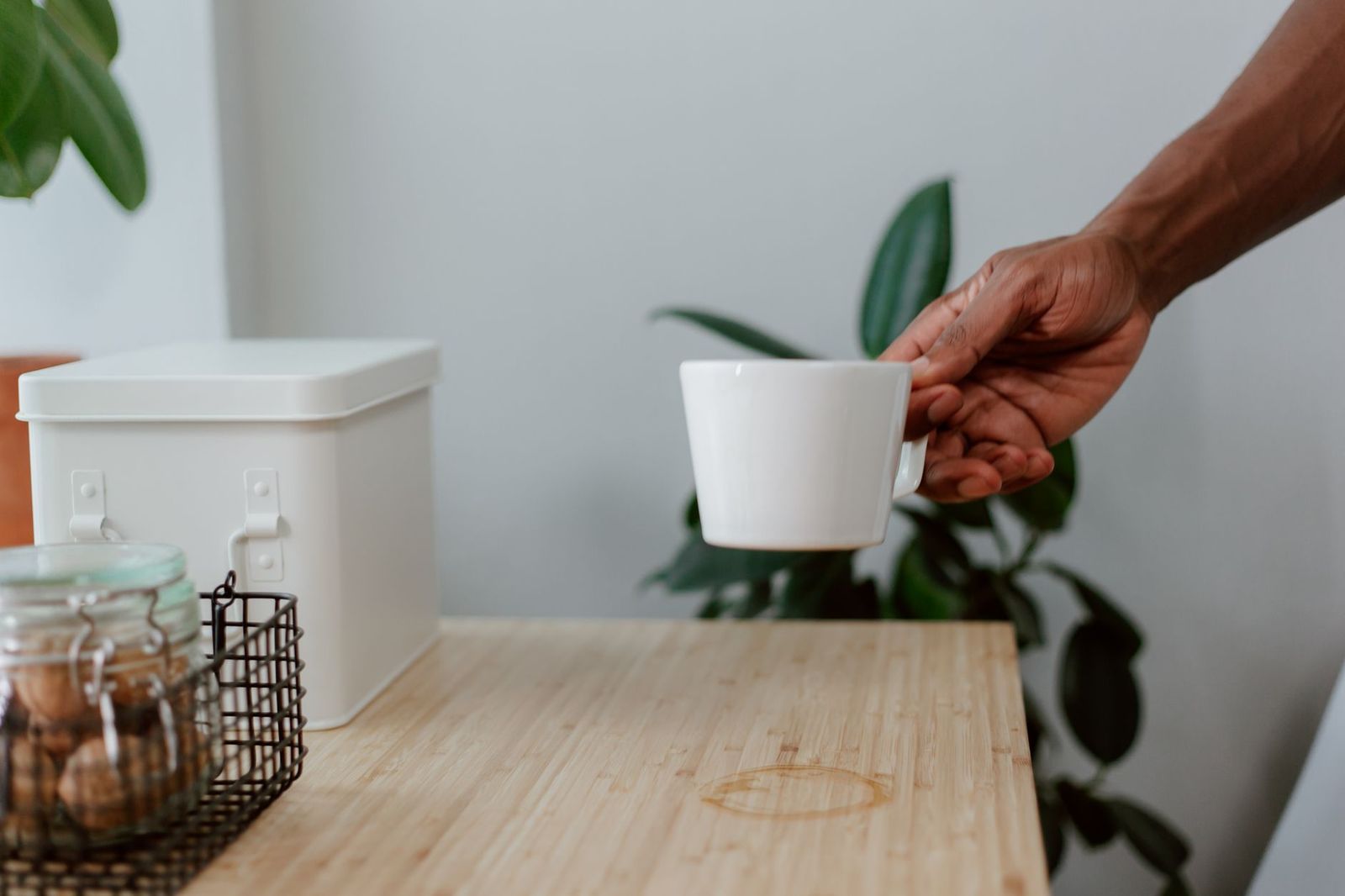 two coffee cups on a kitchen counter, one still full, one stained || two coffee cups kitchen counter one still full one stained