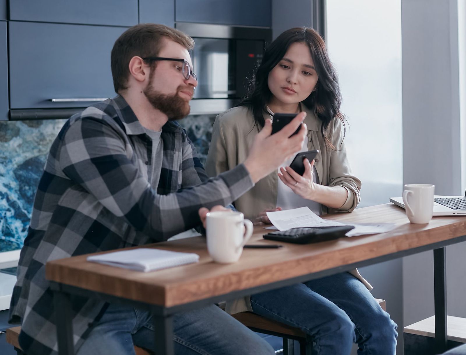 couple their thirties kitchen counter the one mug between them she's standing and he's seated the distance readable sec index card with handwriting table next phone lying face down sec woman her late thirties walking outside coat pocket visible keys hand