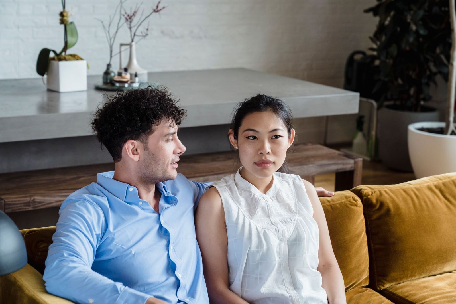 A young couple sitting together on a modern sofa