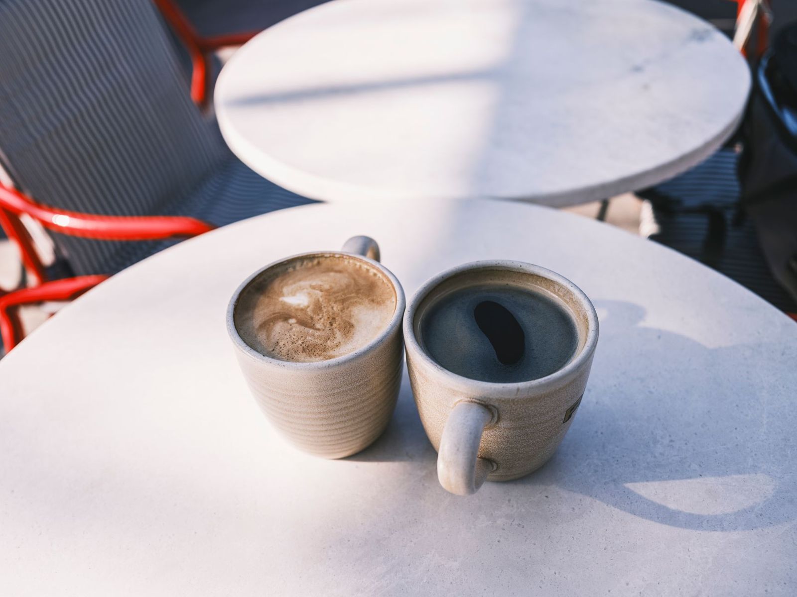 two coffee cups on a café table, one with a lipstick mark, the other full and cold, a conversation that already happened || two coffee cups café table one with lipstick mark the other full and cold conversation that already happened