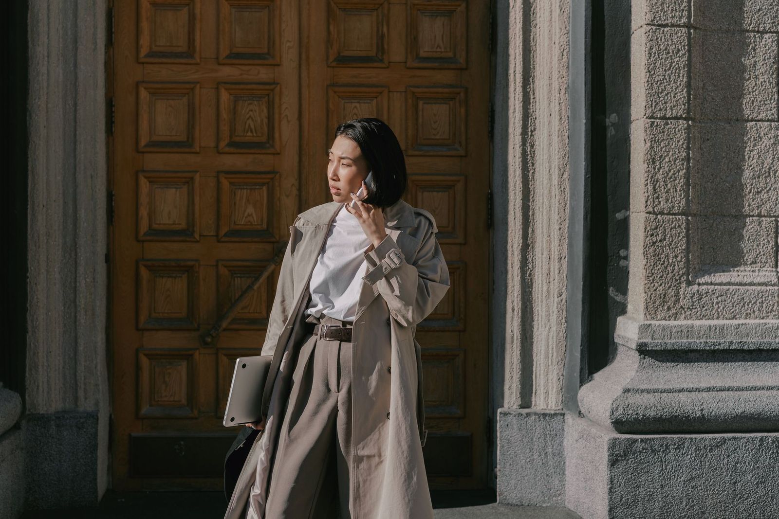 a woman in her late thirties walking outside in daylight, coat on, no phone in hand, leaving || woman her late thirties walking outside coat phone hand leaving